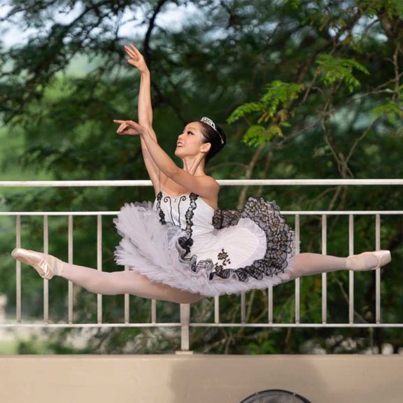 female ballet dancer in air outside