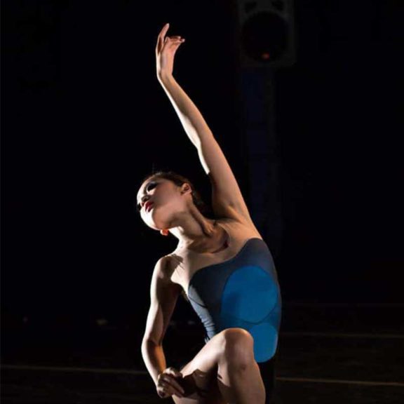 ballet dancer stretching arms overhead
