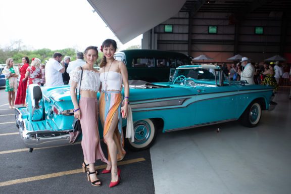 Two Cincinnati Ballet dancers stand in front of vintage car at Club B