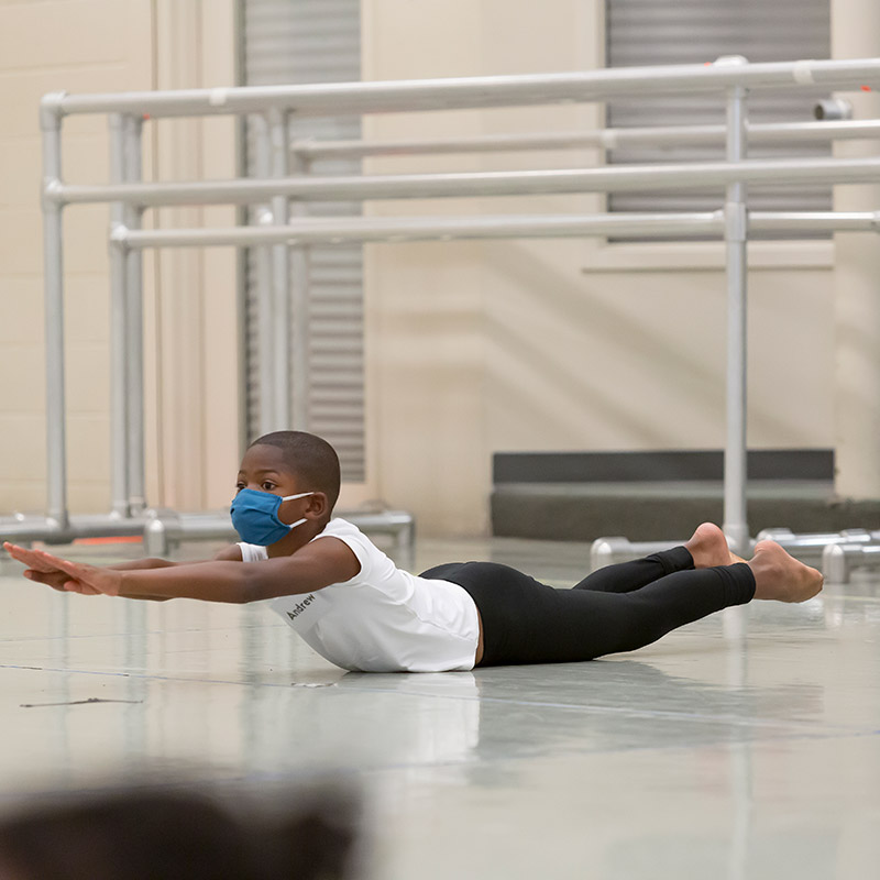 young dancer stretching on the ground