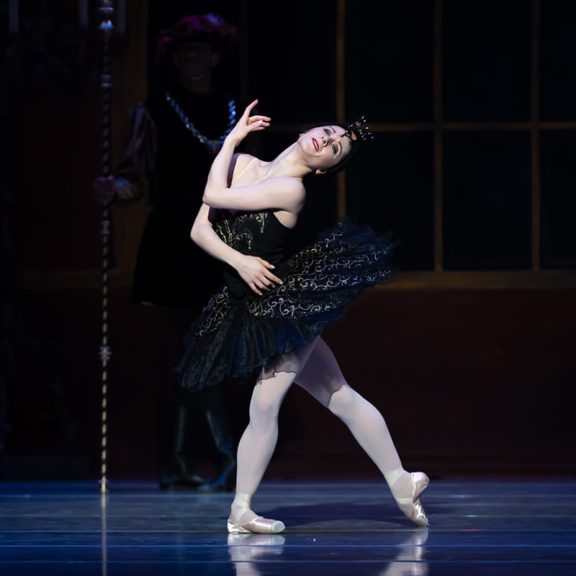 Woman Ballet Dancer in Black Dress on Stage