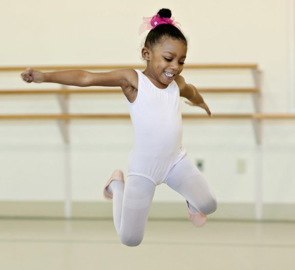 Young child jumping in class