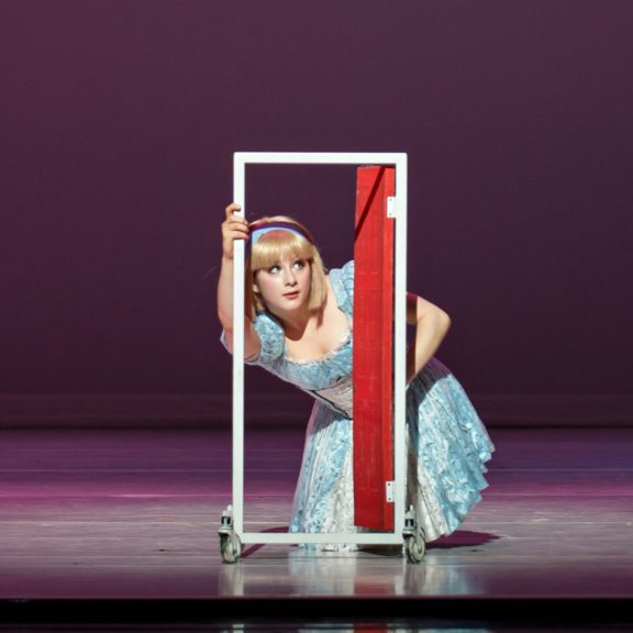 Alice in Wonderland performance looking through small door