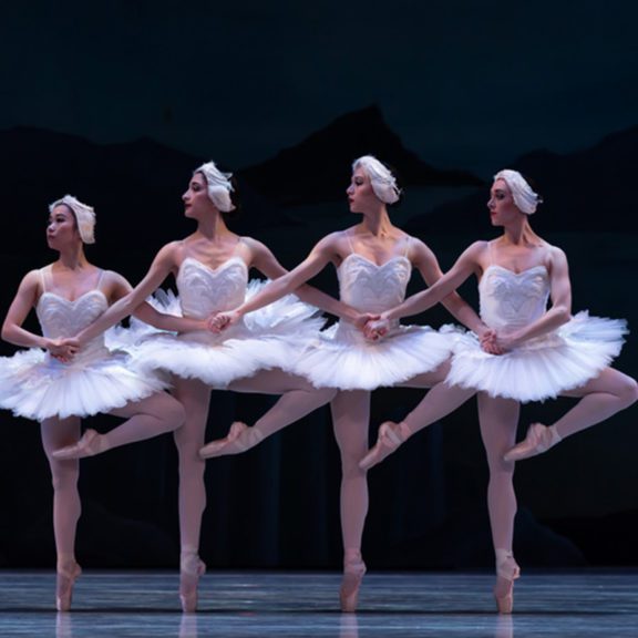 Four ballerinaas perform in Swan Lake