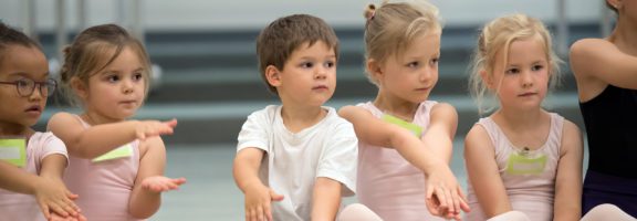 Photo of young children posing during a new student dance training event
