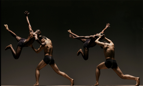 Photo of two male ballet dancers holding two other male ballet dancers in the air