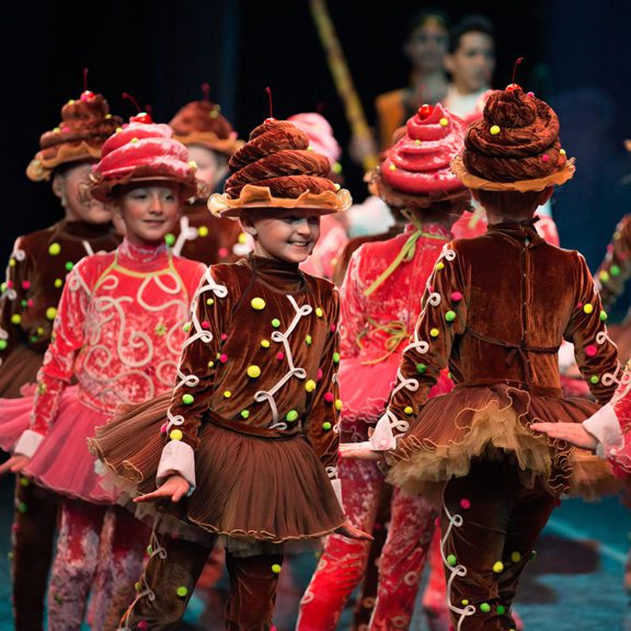 Photo of children ballet dancers dressed as desserts during a performance