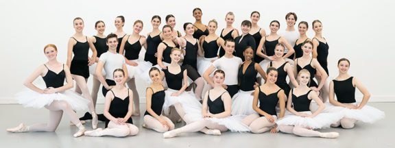 Photo of male and female ballet group professional training division wearing black and white outfits