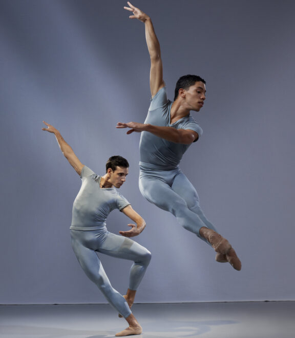 2023-2024 season | Photo of two male ballet dancers posing on stage in blue leotards