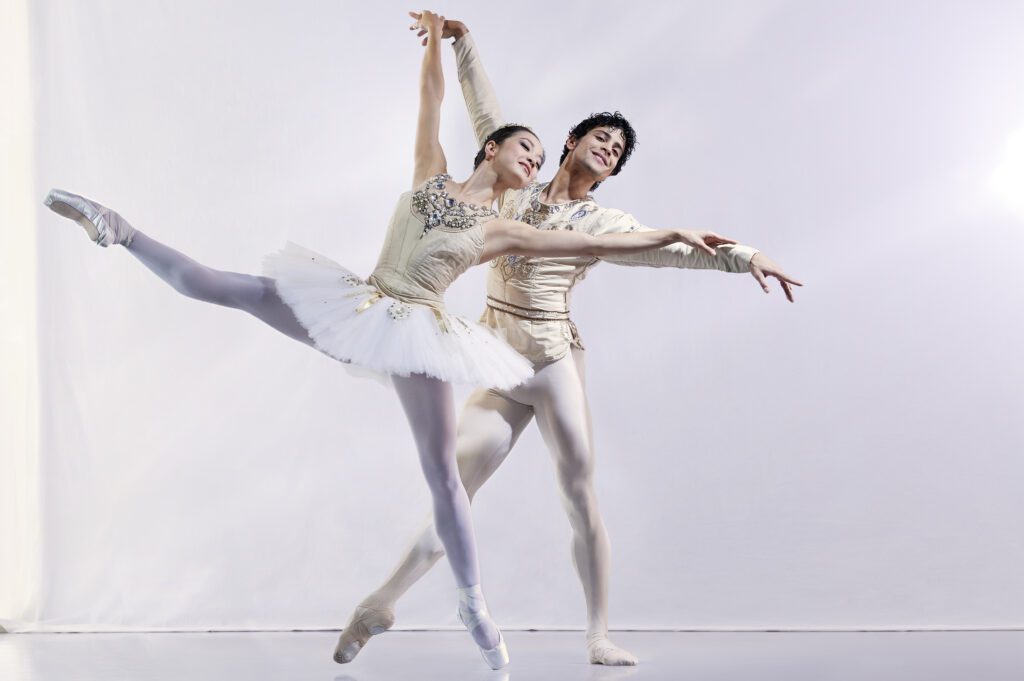 2023-2024 season | Photo of a male and female ballerina posing together in white costumes with jewels on them